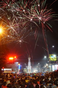 People watching firework display at night