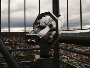 Close-up of metal railing against sky