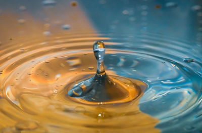 High angle view of drop falling on water