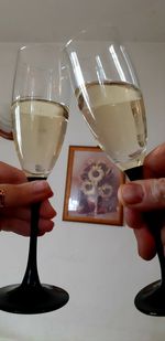 Close-up of hand holding wine glass on table