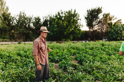 Man looking away standing on agricultural field