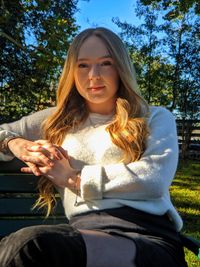 Portrait of young woman sitting outdoors