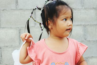 Close-up of girl against wall