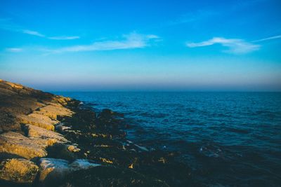 Scenic view of sea against blue sky