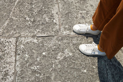 Low section of person standing on footpath