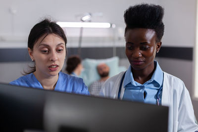 Female healthcare worker using desktop computer at hospital