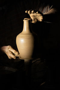 Close-up of hand in vase