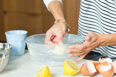 Midsection of woman preparing food on table