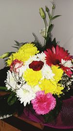 Close-up of multi colored flowers in vase