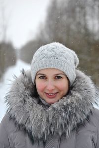 Portrait of smiling young woman in snow
