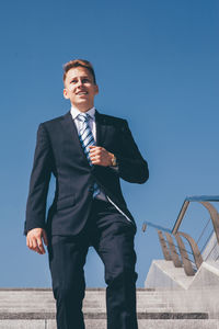 Full length of a young man walking against sky