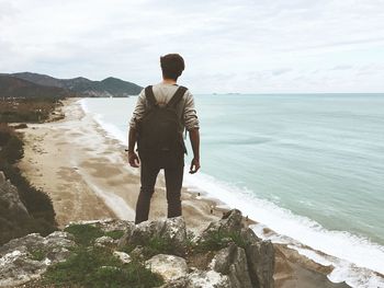 Rear view of man looking at sea