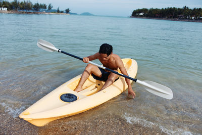 Man kayaking in lake