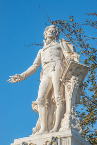 Low angle view of statue against clear blue sky