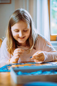 Portrait of a girl holding puzzle