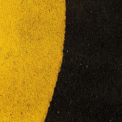 High angle view of yellow road sign on street