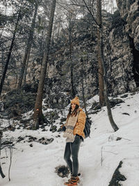 Full length of woman standing on snow covered land