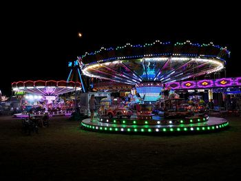 Illuminated ferris wheel at night