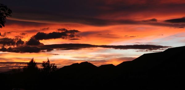 Silhouette of mountain against dramatic sky