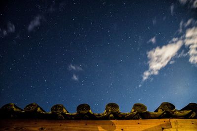 Low angle view of roof against sky at night