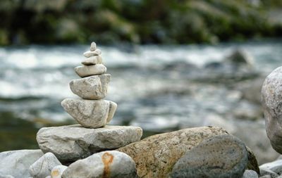 Close-up of stone stack on rock at sea shore