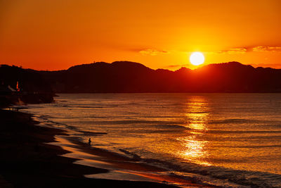 Scenic view of sea against romantic sky at sunrise