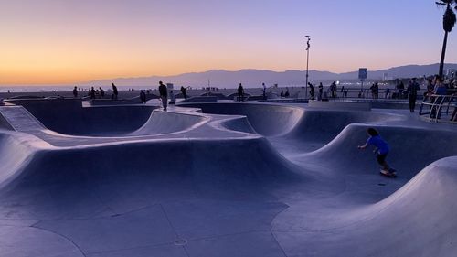 People at skateboard park during sunset