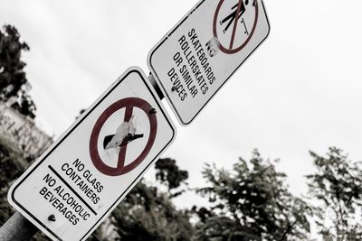 Low angle view of information sign against sky