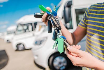 Midsection of man holding keys