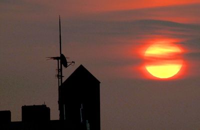 Low angle view of silhouette building against sky during sunset