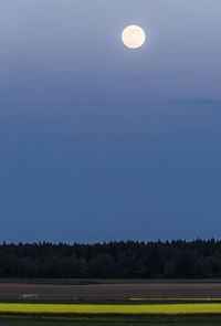 Scenic view of field against clear sky at night