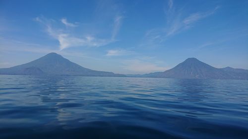 Scenic view of mountains against blue sky