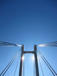 Low angle view of bridge against clear blue sky