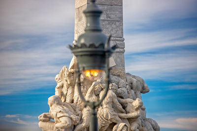 Low angle view of statue against sky