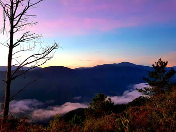 Scenic view of silhouette mountains against sky at sunset