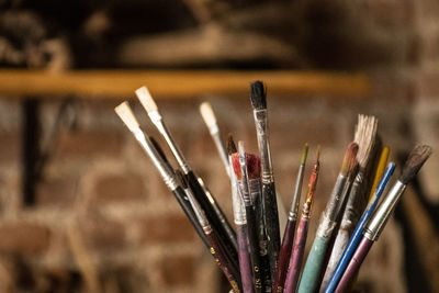 Close-up of paintbrushes in container