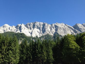 Scenic view of mountains against clear blue sky