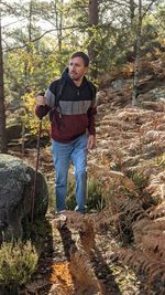 Portrait of man standing in forest