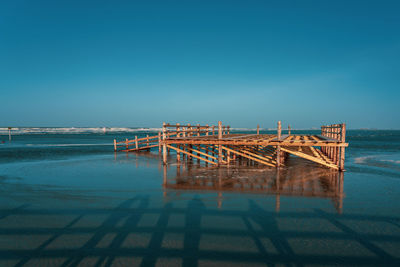 Pile dwelling on the norsee beach of sankt peter-ording in germany