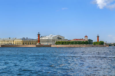 View of building by sea against blue sky