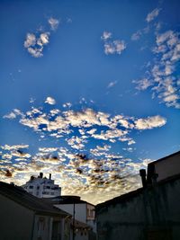 Low angle view of buildings against blue sky