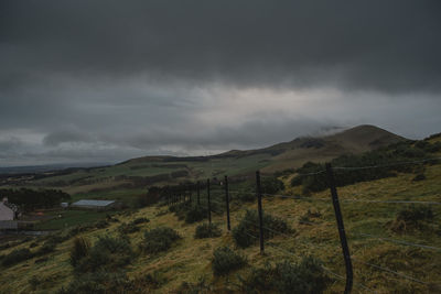 Scenic view of mountains against storm clouds