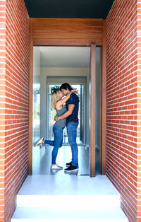 Loving couple standing at doorway