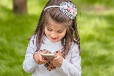 Close-up of girl holding plant