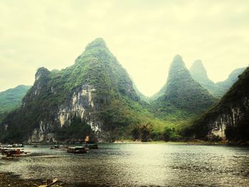 Scenic view of river with mountains in background