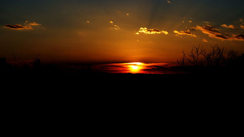 Scenic view of silhouette landscape against sky at sunset