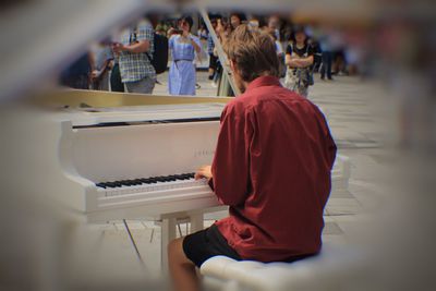 Rear view of woman sitting on stage