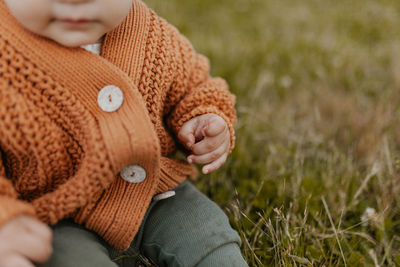 Close-up of woman with hand on field