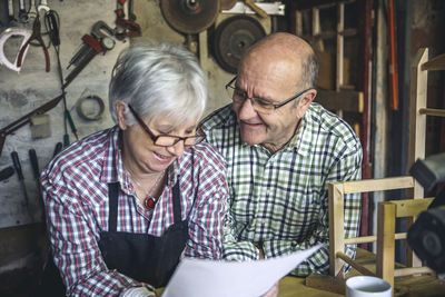 Man and woman sitting on table