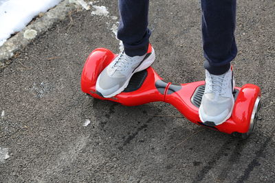 Low section of man riding segway on road